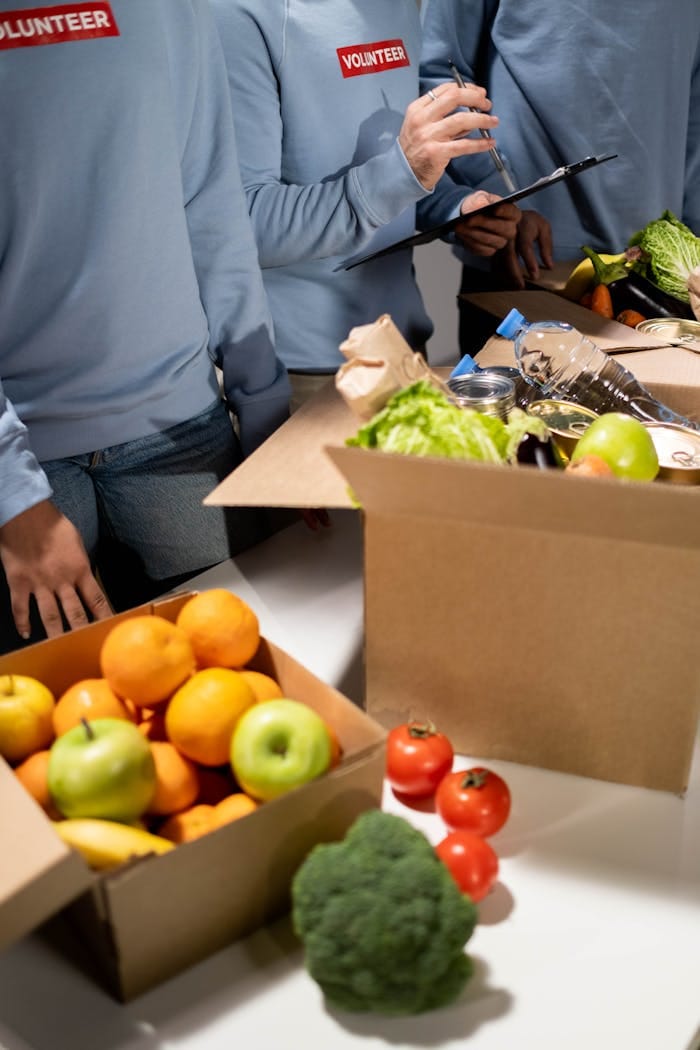 Energetic volunteers organize fresh fruits and vegetables for a community relief effort.